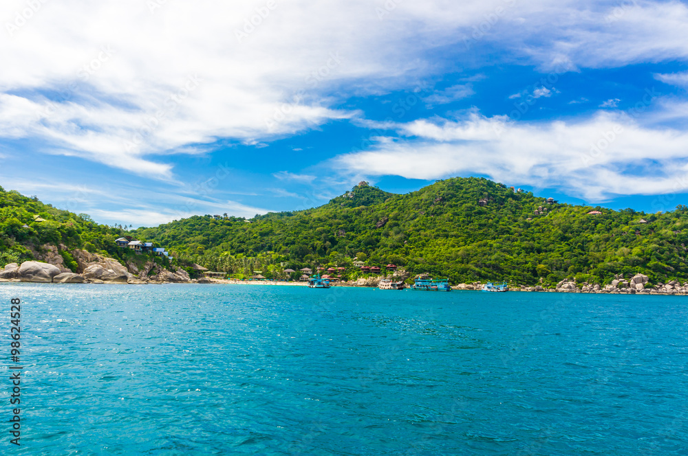 Rocky island with Turquoise Water and Green Palm Trees Rocky island with Turquoise Water and Green Palm Trees