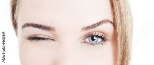 Close-up with beautiful woman eyes and wink