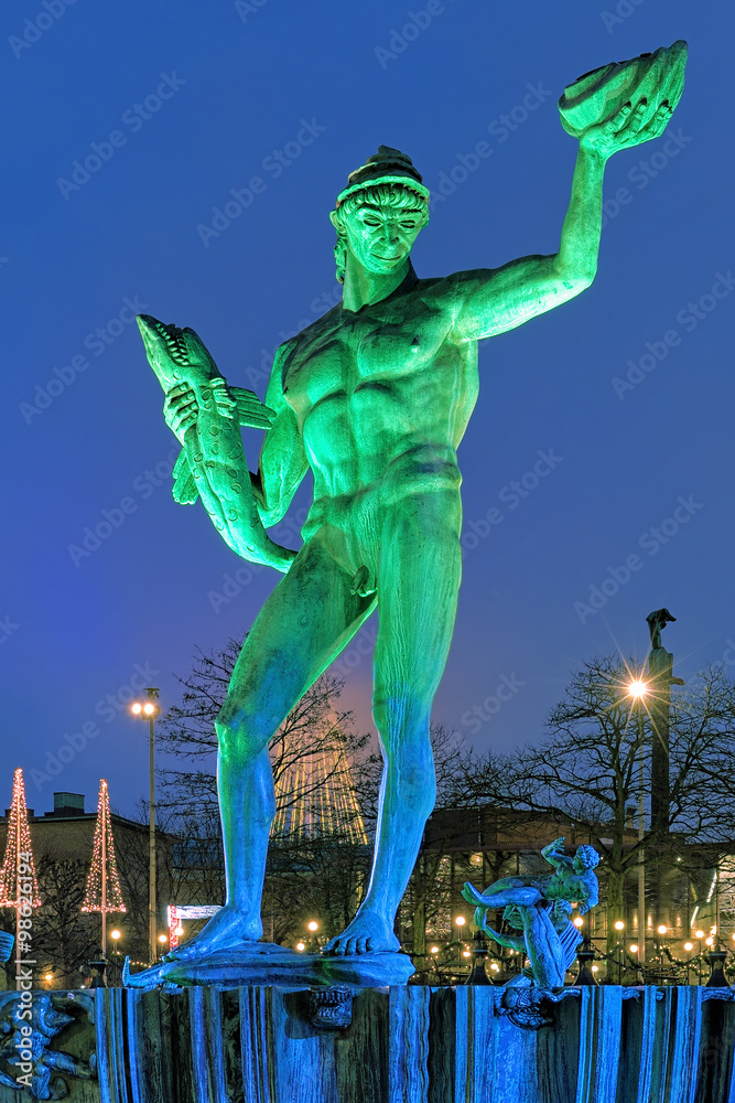 The Poseidon Fountain in Gothenburg with green-blue illumination in the evening, Sweden