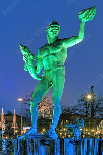 Obraz na płótnie The Poseidon Fountain in Gothenburg with green-blue illumination in the evening, Sweden w salonie