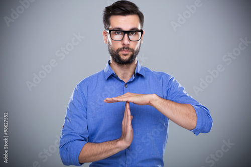 Cuadro en lienzo Man showing time out gesture