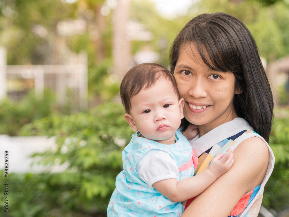 Beauty Asian mother carry cute baby in garden outdoor. Beauty Asian mother carry cute baby in garden outdoor.