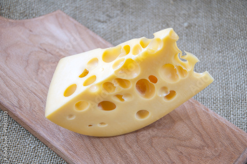 Emmental cheese on wooden cutting board