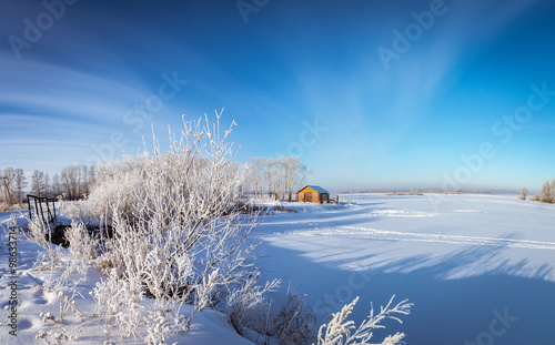 Зимняя панорама замерзшего озера с кирпичным домиком, Россия, Урал