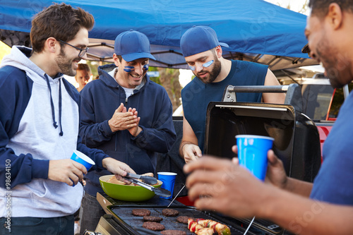 Photography Group Of Male Sports Fans Tailgating In Stadium Car Park
