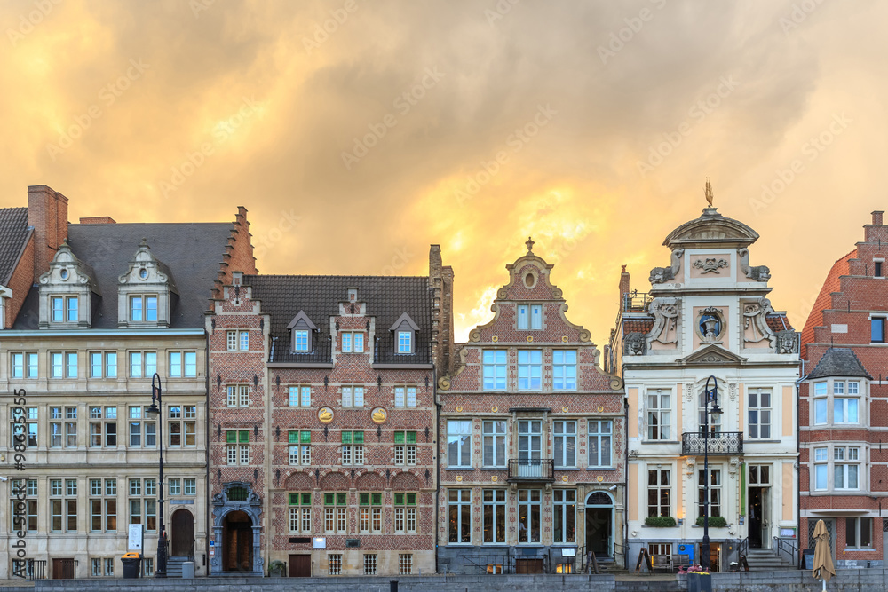 Beautiful sunset old buildings on Korenlei embankment in Ghent