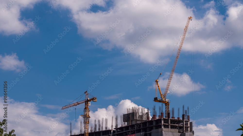 Time-lapse, the construction of a condominium building, Crane and steel scaffolding. 