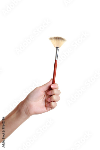 Female hand with brush for make-up isolated on white