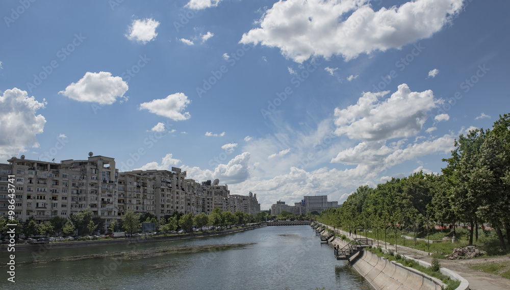 Bucharest, Romania - May 07, 2015: Bucharest skyline with Dimbovita river and Parliament Palace in front