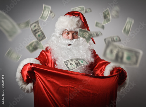 Santa Claus and sack with dollars.