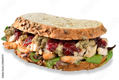 Turkey, chicken sandwich from Christmas leftovers, stuffing and cranberry sauce. Isolated