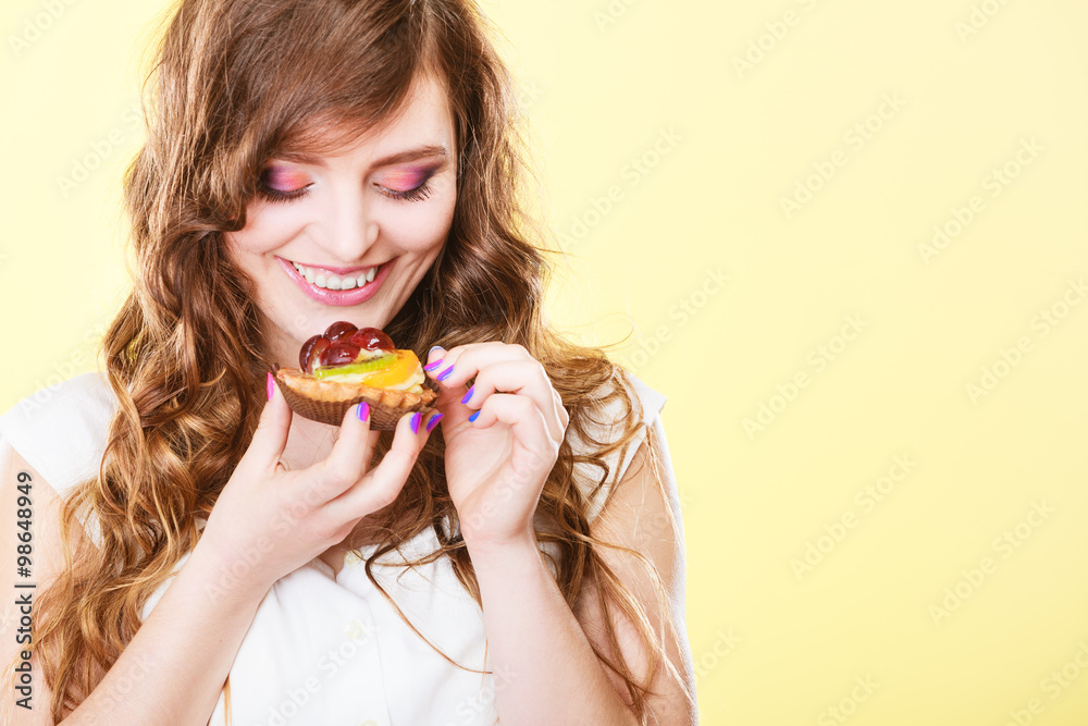Smiling cute woman holds fruit cake in hand Smiling cute woman holds fruit cake in hand