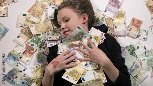 Rich girl in love with her money, too much cash, financially secure, euro bills photo