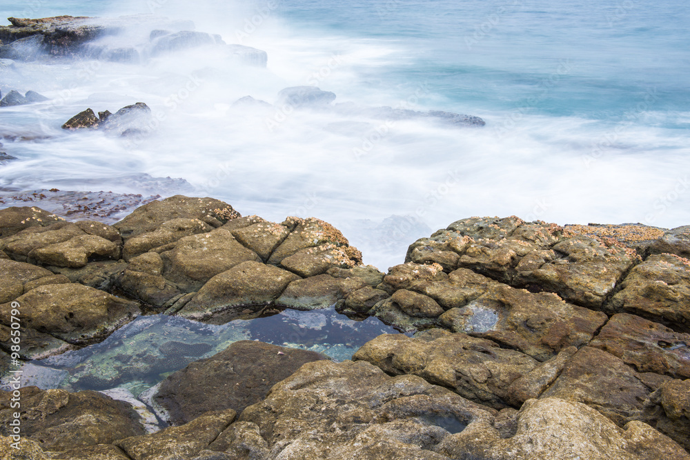 Rocks and waves at Point Cartwright beach in the afternoon. Sunshine Coast, Queensland. Rocks and waves at Point Cartwright beach in the afternoon. Sunshine Coast, Queensland.