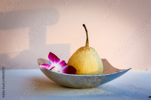 Peach and orchid flower in the stainless bowl