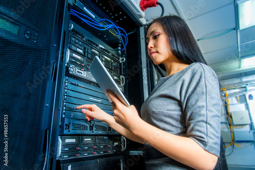 Engineer businesswoman in network server room photo