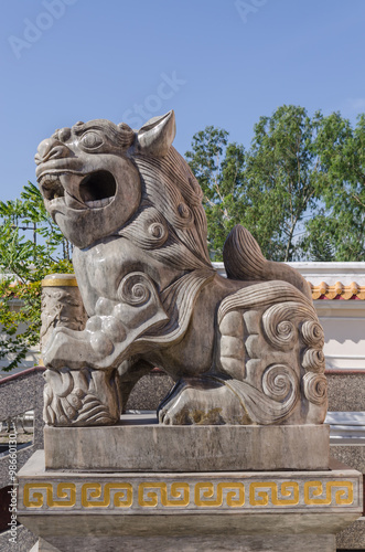 Protective Chinese lion at front door of buddhist temple.