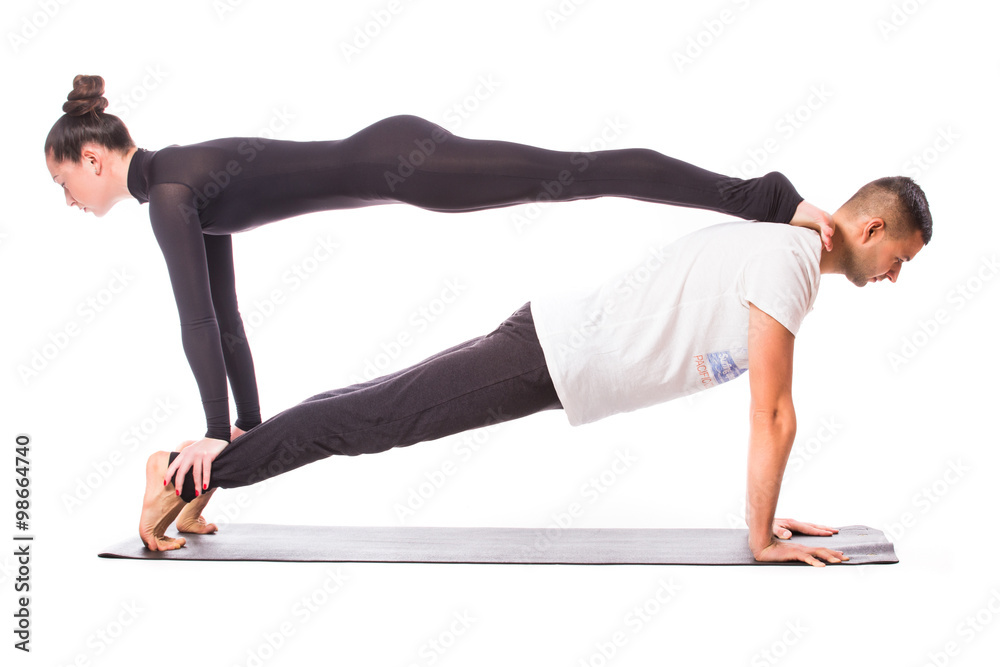 Young healthy couple in yoga position on white background Young healthy couple in yoga position on white background