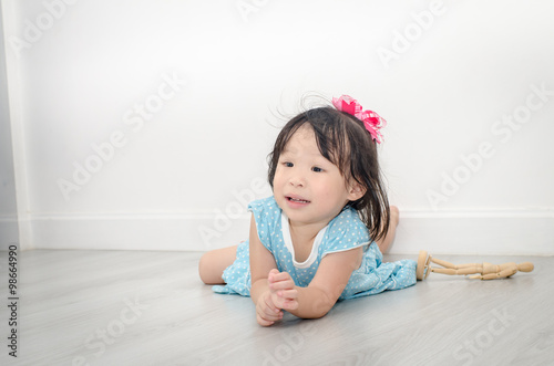 close-up portrait of a cute girl, lying on the floor in the livi