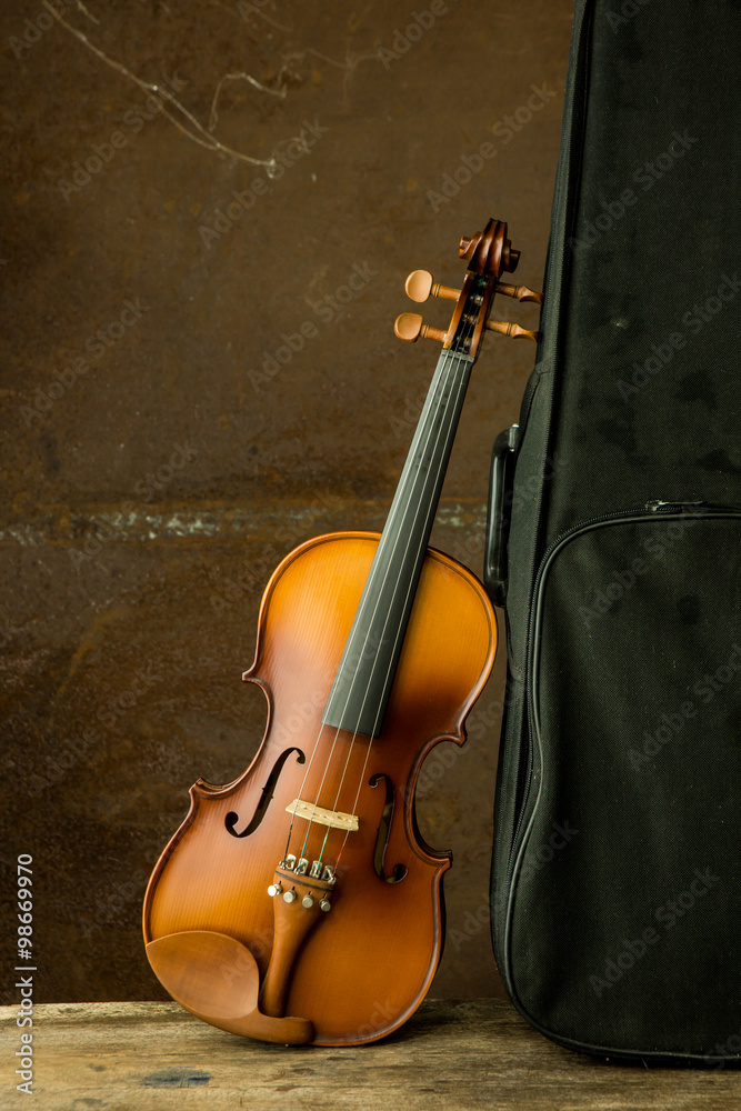 vintage violin resting against an old steel background