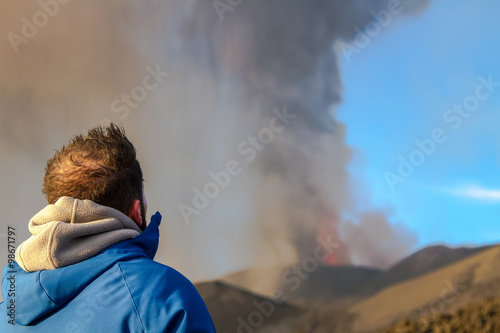 man look the Volcano eruption. Mount Etna erupting from the crater Voragine 