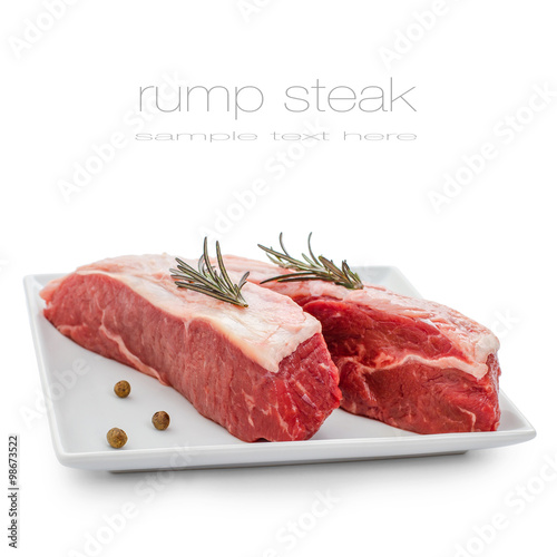 Fresh rump steaks with rosemary on plate