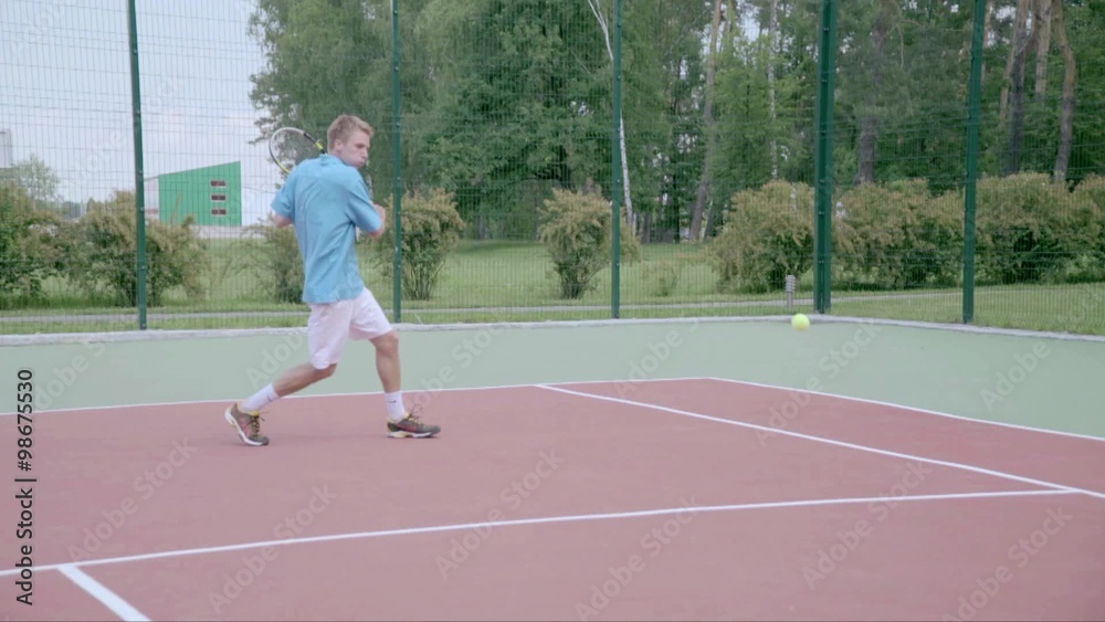 Tennis player uses backhand slice on the half court. Slow motion Tennis player uses backhand slice on the half court. Slow motion