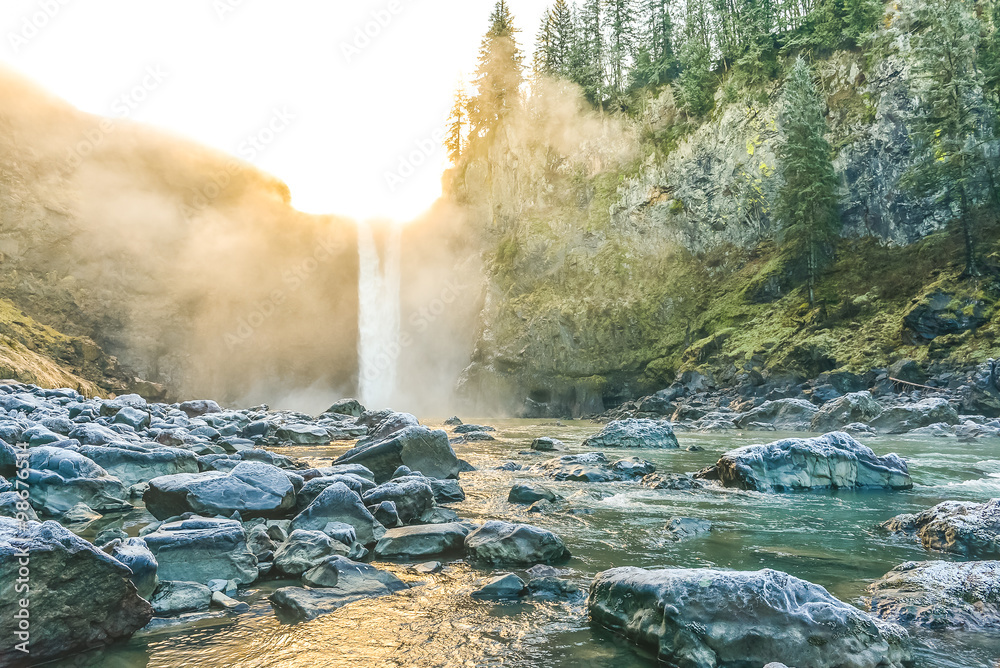 Fototapeta premium scenic view of Snoqualmie falls with golden fog when sunrise in winter season,Washington,USA.