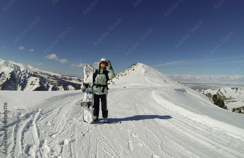Snowboarder on the top of the mountain in Karakol, Kyrgyzstan