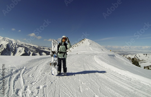 Snowboarder on the top of the mountain in Karakol, Kyrgyzstan