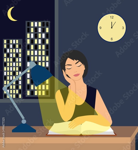 girl reading a book under a table lamp on the table. against the backdrop of the city at night