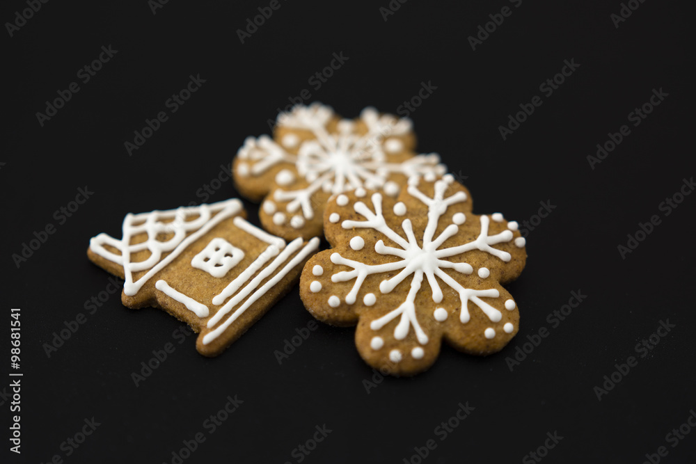 Gingerbread house and snowflakes on a black background Gingerbread house and snowflakes on a black background