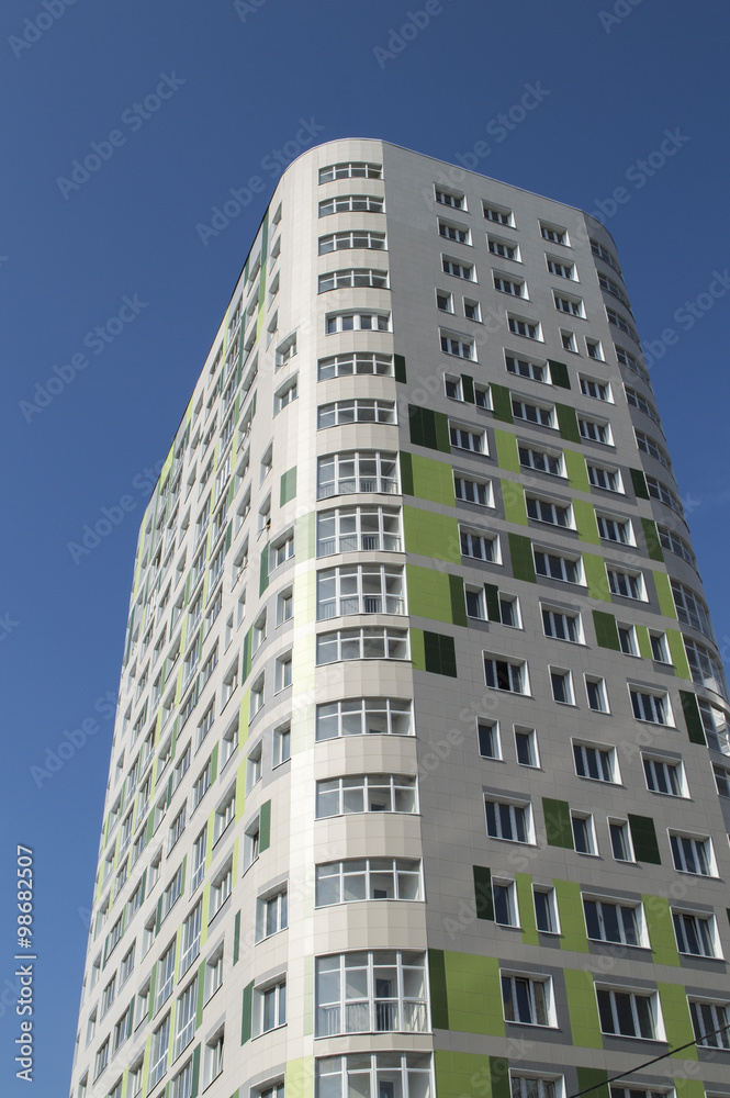 The new inhabited multi-storey building against a clear sky The new inhabited multi-storey building against a clear sky