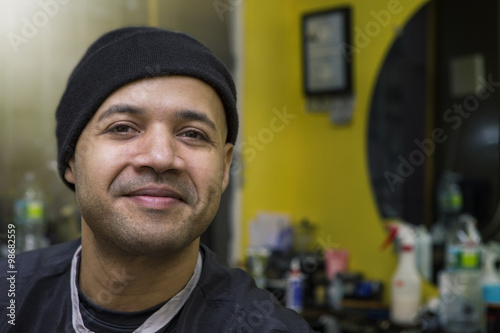 Barber posing in his shop.