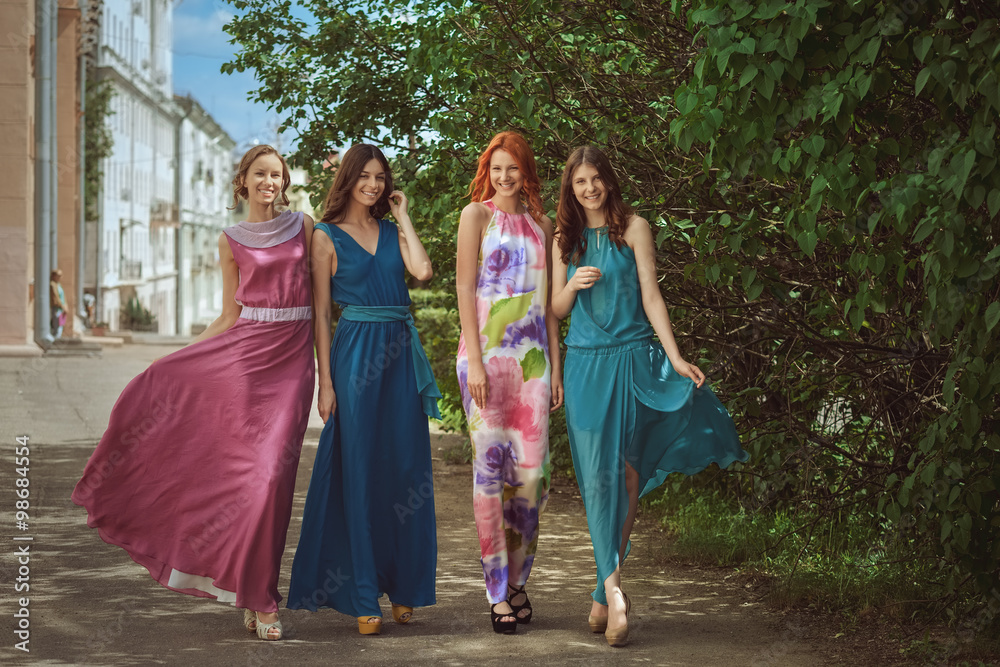 four young girls walk along the street four young girls walk along the street