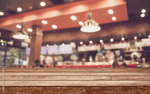 Empty wood table top with restaurant blur with bokeh background,Product display template