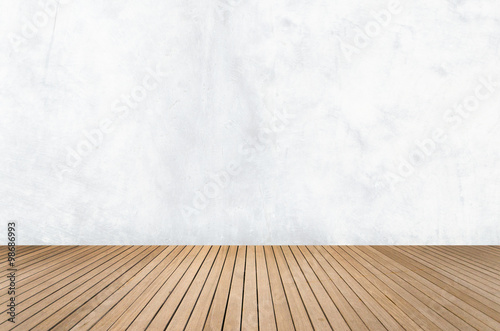 Empty room with white concrete wall and wooden floor