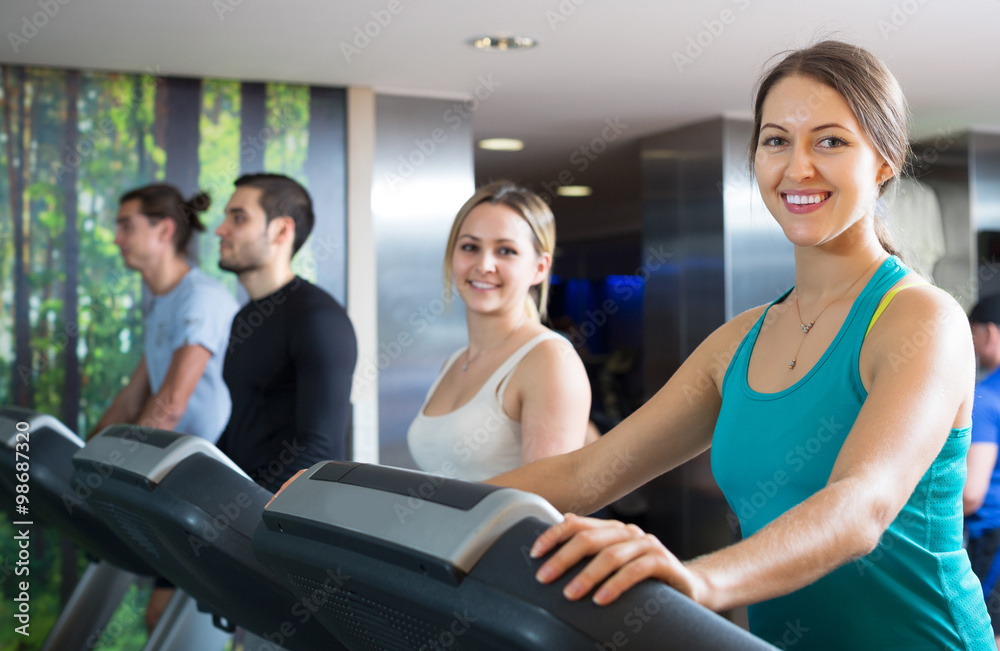 Adults training on treadmills