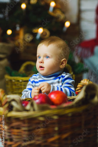 one years old child celebrating holidays near Christmas tree