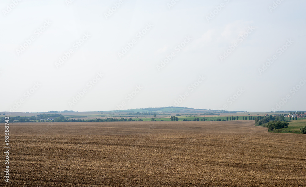 Fields with village and blue sky
