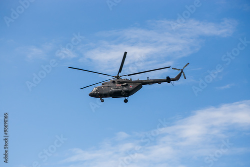 Russian military helicopter MI-8 in the blue sky
