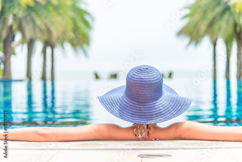 Woman wearing hat in the hotel pool resort