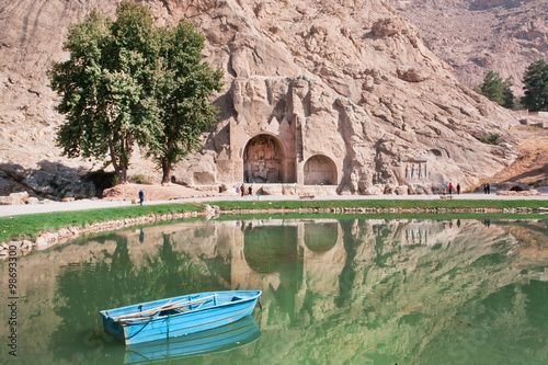 River boat in the lake of oasis near the historical landmarks in Iran photo