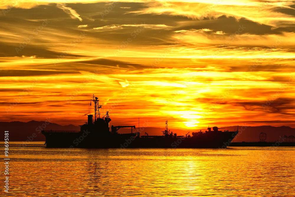 Bulk-carrier ship at sunset in the sea