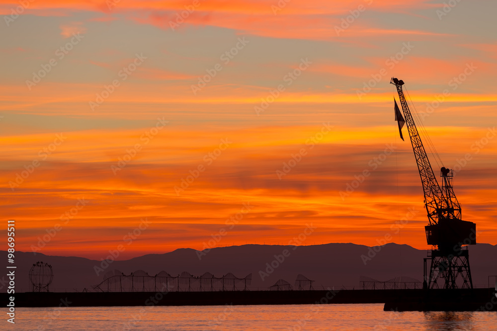 Silhouette of a drilling rig against dramatic sunset Silhouette of a drilling rig against dramatic sunset