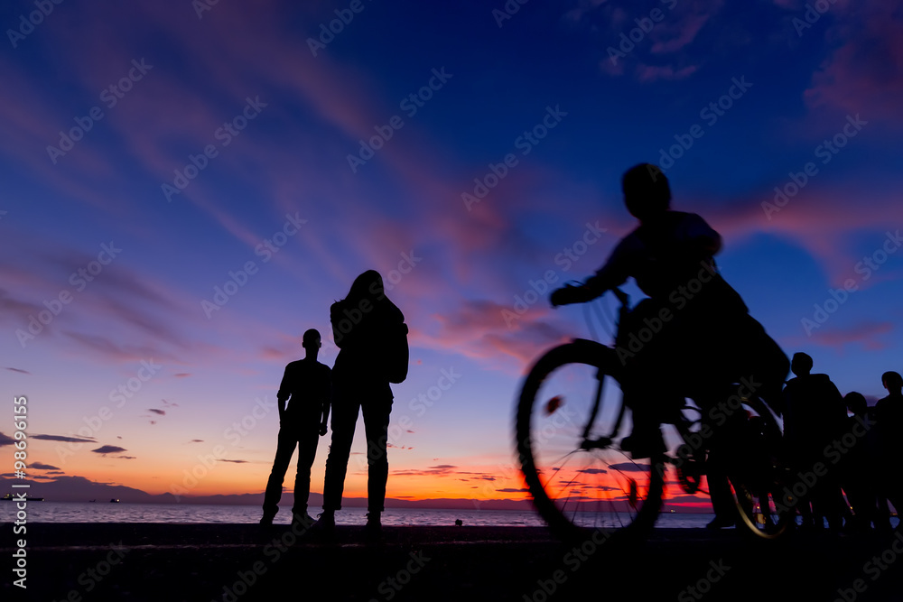 The Silhouettes are doing Activities on the Beach at Sunset The Silhouettes are doing Activities on the Beach at Sunset