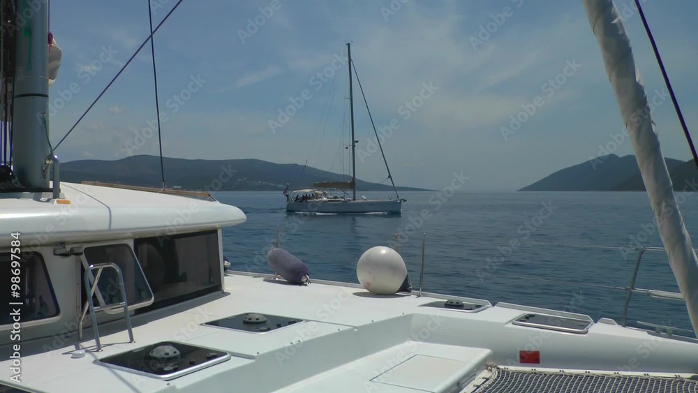 Sailing yacht running a parallel course, the view from a sailing catamaran.
Sailing yacht running a parallel course, the view from a sailing catamaran.