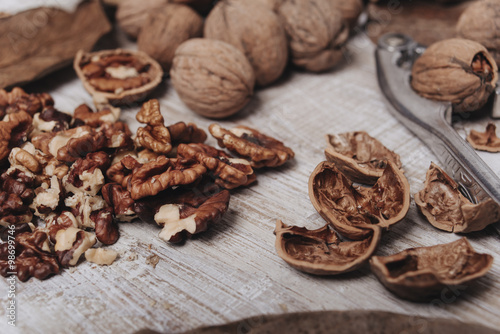 Walnuts in a pile with nutcracker