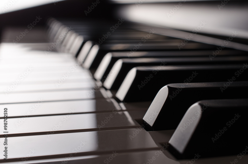 Piano keyboard in the backlight - side view Piano keyboard in the backlight - side view
