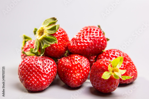 A few berries fresh strawberries on a gray background  Not in is